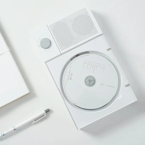 White electronic device with a CD-like disc on a light gray background