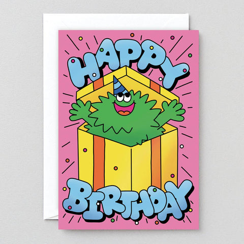 Birthday card with a cartoon character and 'Happy Birthday' text on a pink background