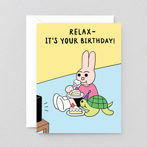 Birthday card with cartoon character and text 'Relax, it's your birthday!' on a yellow and blue background.