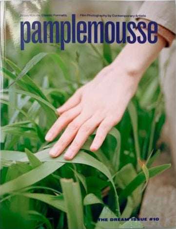 Cover of 'Pamplemousse THE DREAM ISSUE #10' featuring a close-up photograph of a hand with a camera, surrounded by greenery and the title text.