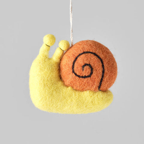 Felted snail ornament on a gray background