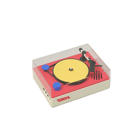 Small model of a turntable with a yellow record on a gray background