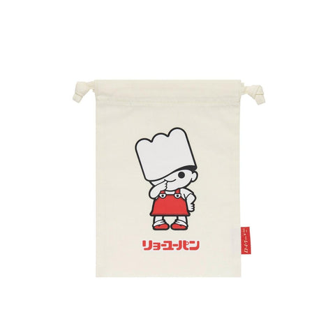 An off-white canvas drawstring pouch featuring a cartoon character resembling a chef with a white hat and red apron, with red Japanese text below and a small red tag on the right side.